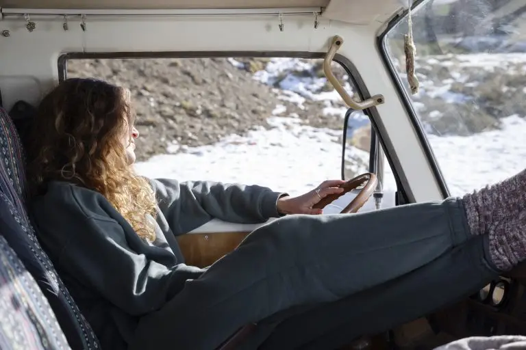 young-woman-inside-camper-van-winter-trip